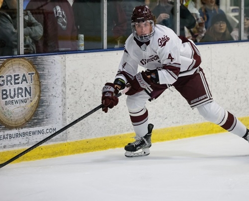 Hockey player skating with puck