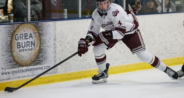 Hockey player skating with puck